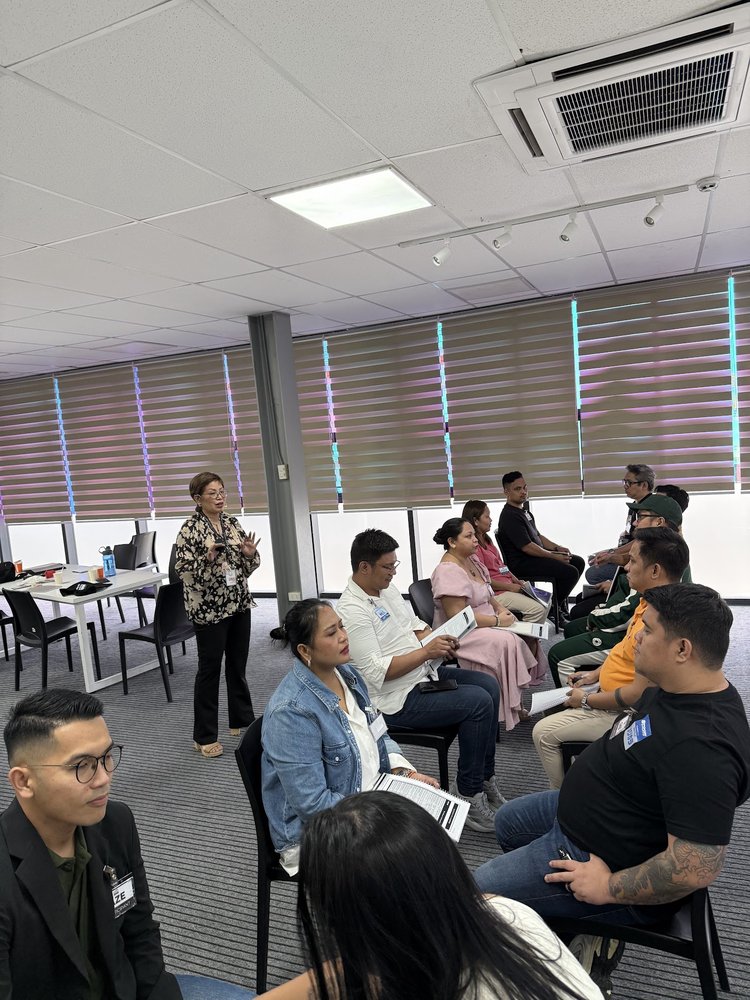Coach Gina Katigbak teaches an engaged room of participants during the live intensive.